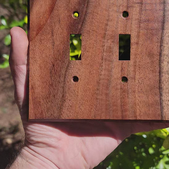 Video of Walnut wood plates in sunlight. Sunlight bounces of the surface in a smooth and elegant way 